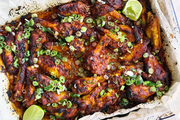 Sweet and smokey chicken wings with spring onions and lime