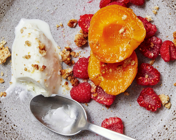 Sweet cheese ice cream with apricots, raspberries, and honey granola