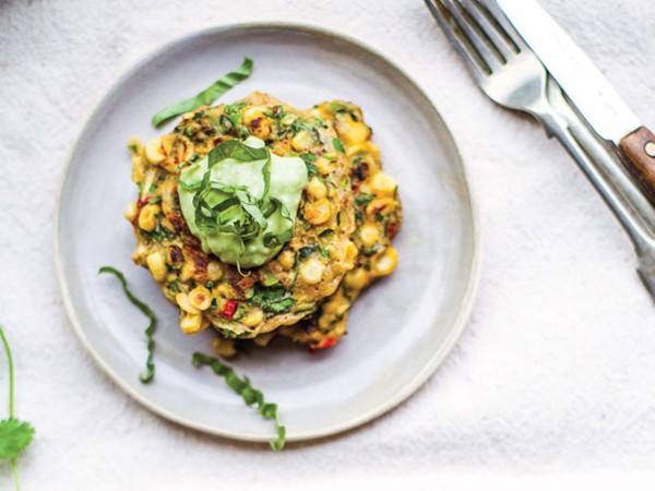 Sweet corn and squash fritters with avocado crema