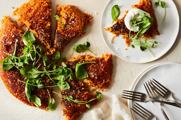 Sweet potato–apple rosti with leafy greens & sour cream