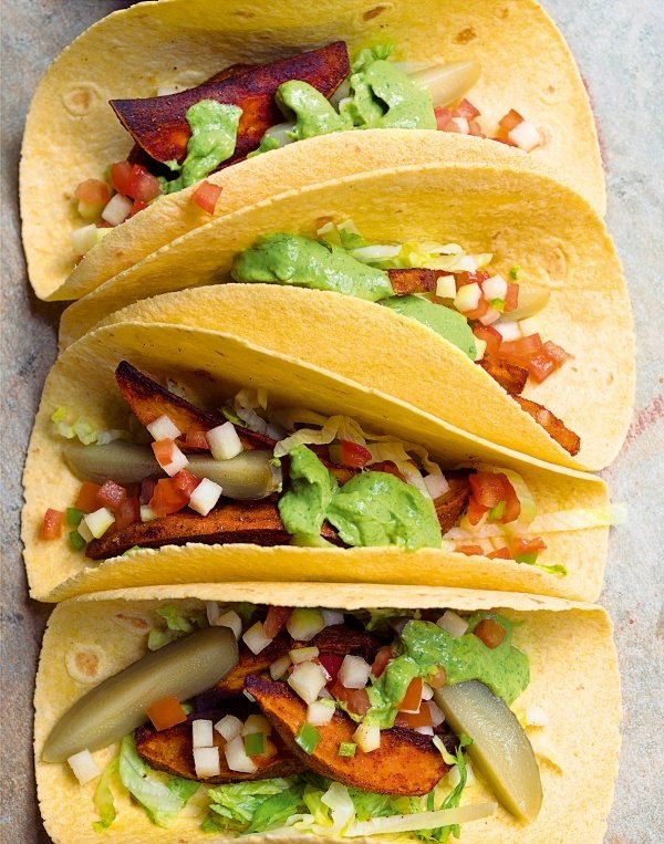 Sweet potato tacos with avocado and coriander sauce and a tomato and pear relish