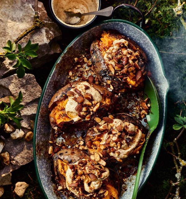Sweet potatoes baked in the embers, with almond tahini and smoked almonds