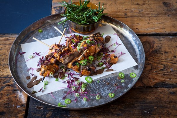  Sweet soy, ginger and lemongrass salmon skewers, black sesame and dried lime dressing