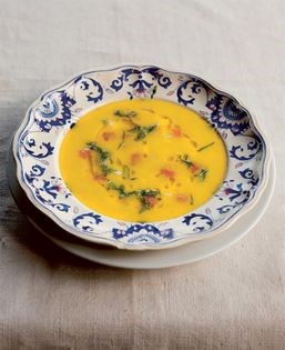 Sweetcorn and yellow pepper soup with tomato, goat's cheese and mint