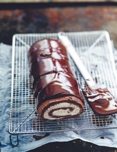 Swiss roll with dark chocolate icing and whipped mascarpone cream
