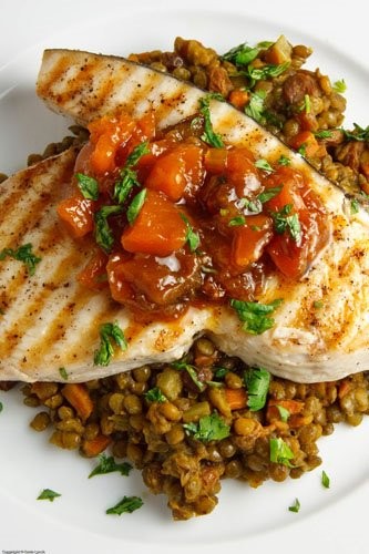 Swordfish steak with mango chutney on curried lentils