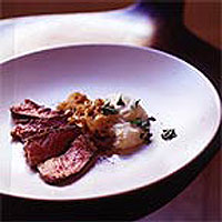 Szechuan pepper-crusted steak smothered with onions