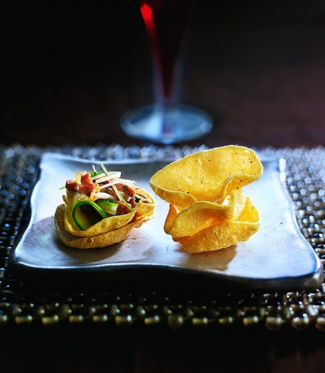 Tamarind duck and herb salad on mini poppadums