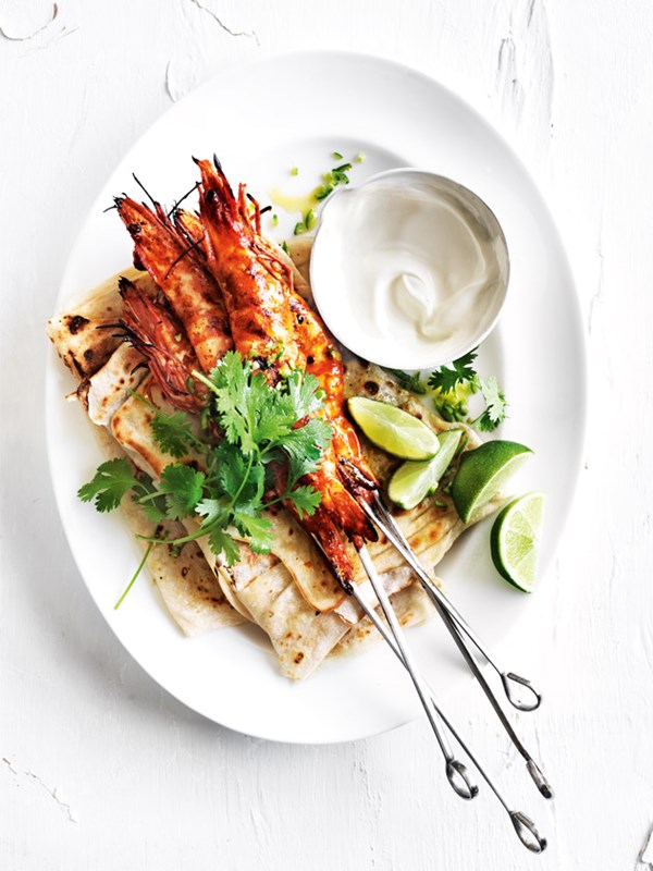 Tandoori prawn skewers with roti and lime yoghurt dressing