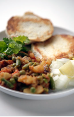 Tangy vegetable curry served with buttered bread rolls (Pav bhaji)