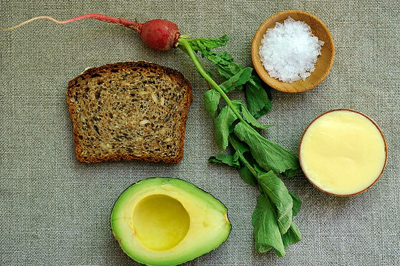 Tartine with mustard mayo and mashed avocado and radishes with butter and salt