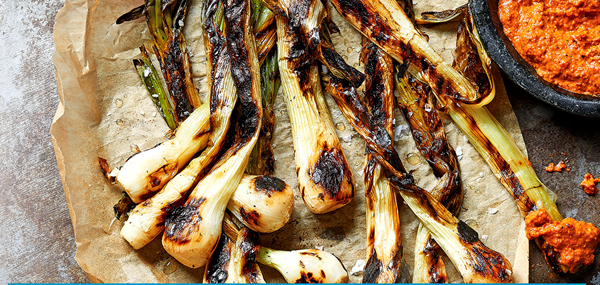 Tender spring onions with charred romesco