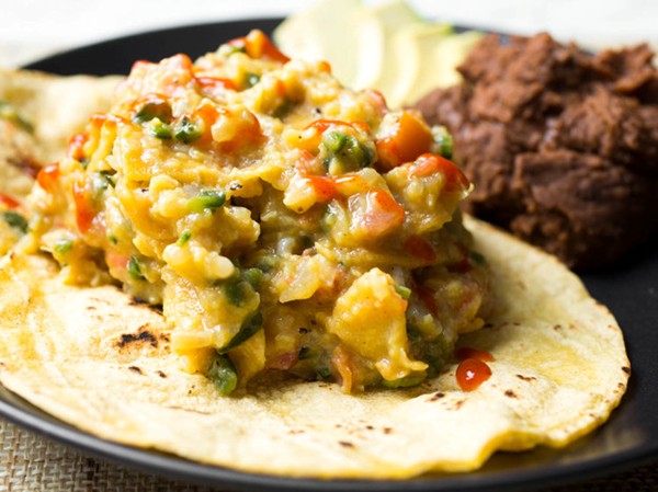 Tex-Mex migas with scrambled eggs, tortilla chips, and chilies