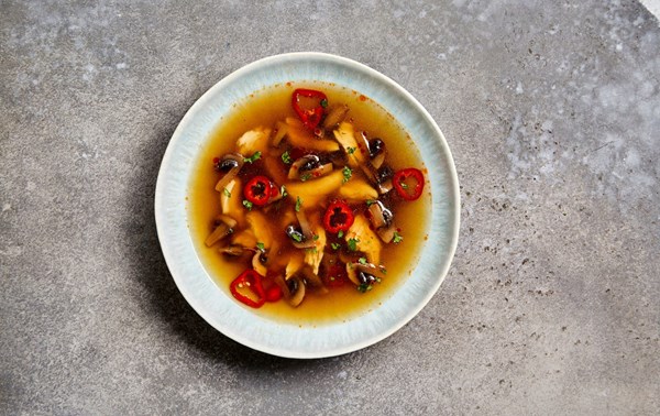 Thai hot and sour soup with chicken and mushrooms