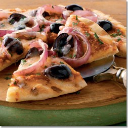 Thin-crusted pizzas with grilled red onions and black olives