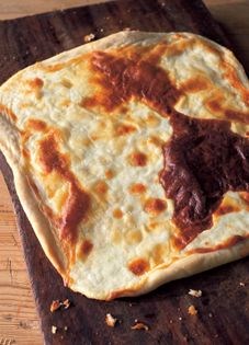 Thin pizza with Stracchino cheese