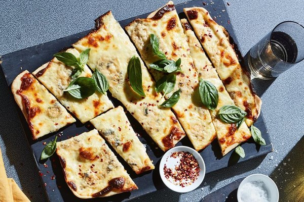 Three-cheese and basil pizza