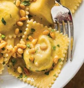 Three-cheese ravioli with browned butter-pine nut sauce
