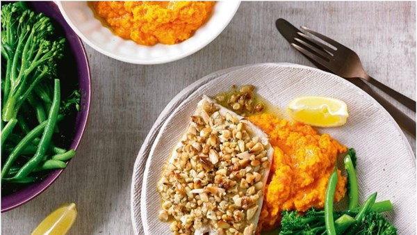 Thyme and nut-crusted fish with carrot mash and greens