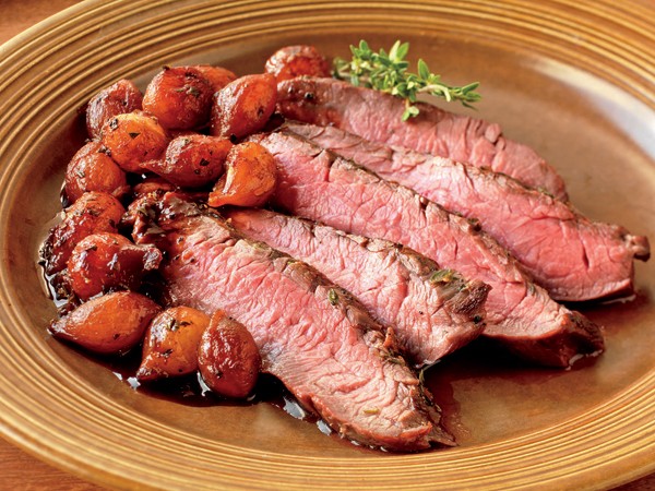 Thyme-rubbed flank steak with balsamic pearl onions