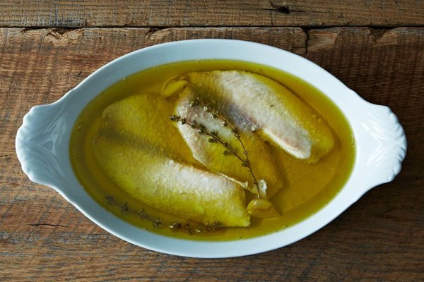 Tilapia poached in olive oil with garlic and thyme