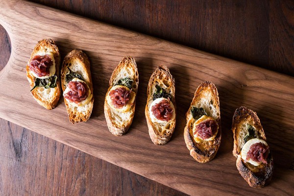Toasted goat cheese crostini with basil and red onion jam