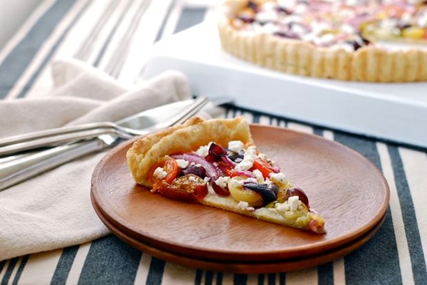 Tomato and Concord grape tart with a cornmeal black pepper crust