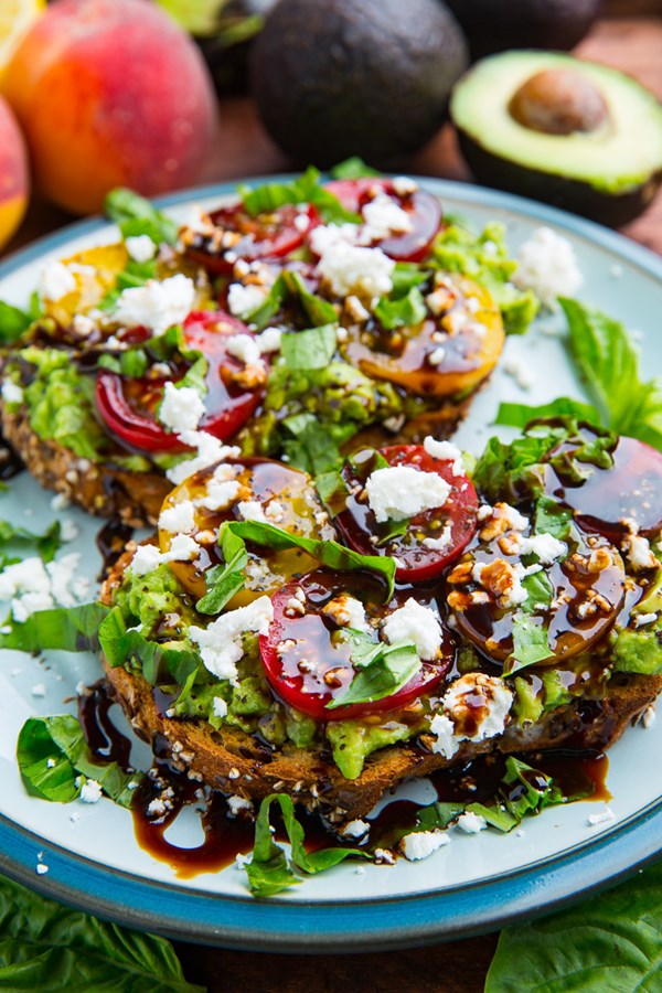 Tomato and goat cheese avocado toast with balsamic glaze
