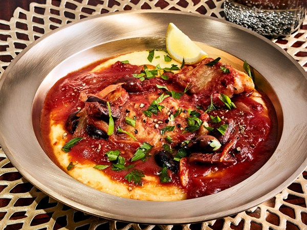 Tomato-braised baccalà with olives and polenta
