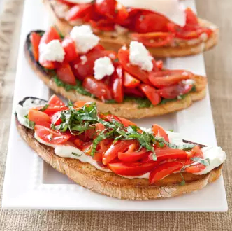 Tomato bruschetta with arugula pesto and goat cheese