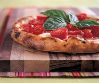 Tomato, buffalo mozzarella, olive oil, basil, and cherry tomato pizza (Pizza Regina Margherita)