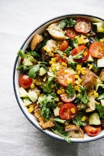 Tomato panzanella with corn, cucumbers, and herb salad