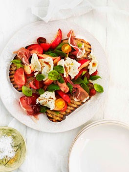 Tomato, prosciutto, peach, basil and mozzarella salad on bruschetta