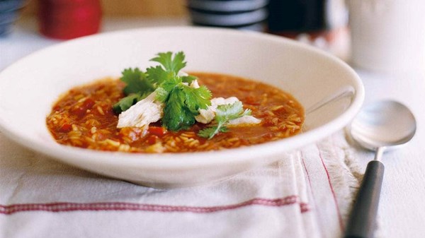 Tomato rice and orange soup with shredded chicken