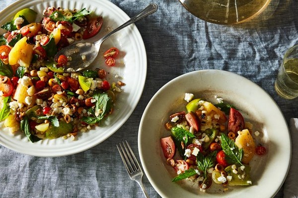 Tomato salad with grilled corn, feta, and hazelnuts