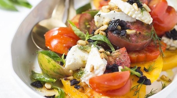 Tomato salad with ricotta, dried olives and pinenuts