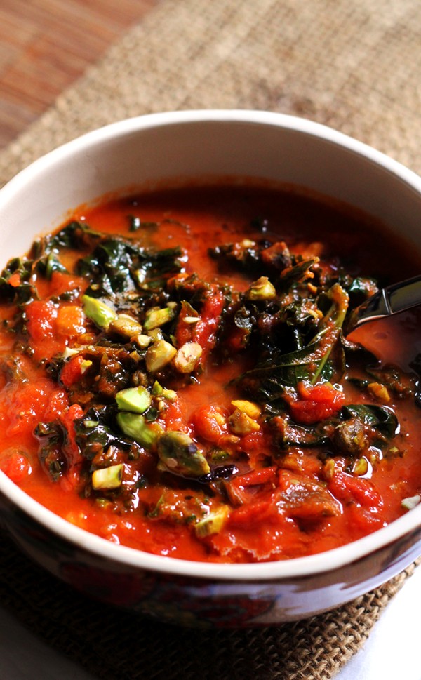 Tomato soup with brown butter, kale, and pistachios