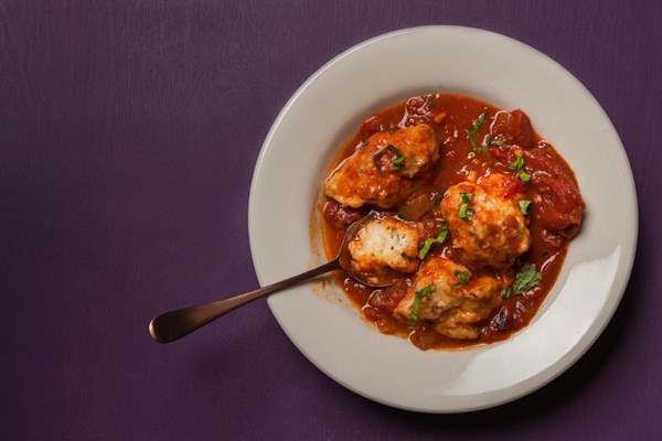 Tomato stew with basil dumplings