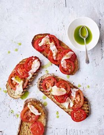 Tomatoes and lardo on toast with basil oil