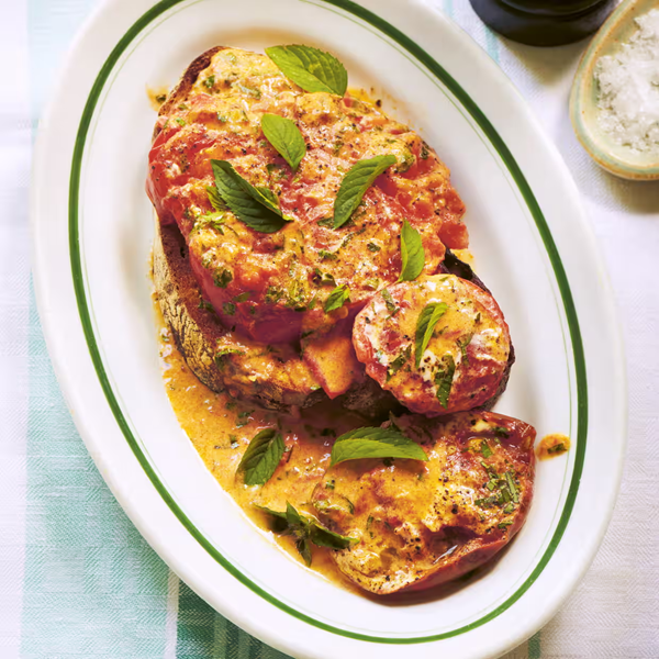 Tomatoes cooked in creme fraiche with mint on toast