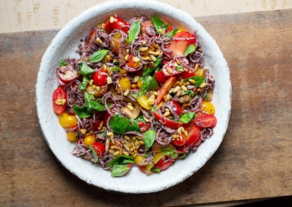 Tomatoes with sumac onions and pine nuts
