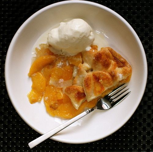 Top crust peach and cardamom pie with cardamom-vanilla ice cream