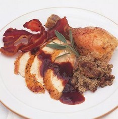 Traditional roast chicken with apple, sage and onion stuffing, cranberry and sage sauce and chicken-giblet gravy