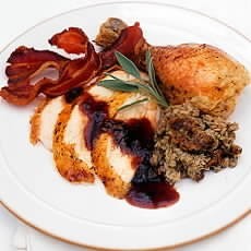 Traditional roast chicken with apple, sage and onion stuffing, cranberry and sage sauce and chicken-giblet gravy