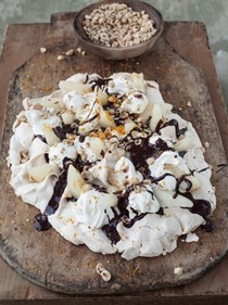 Tray-baked meringue with pears, cream, toasted hazelnuts and chocolate sauce