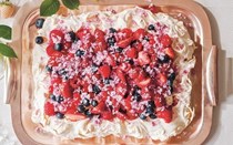 Tray Pavlova with summer berries and rose sugar