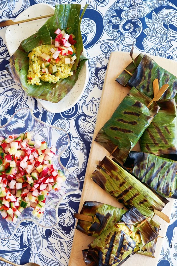 Trevally & taro cakes in banana leaf with cucumber, radish & chilli relish
