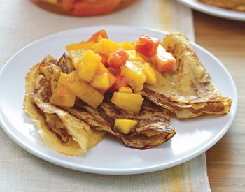 Tropical fruit crepes with vanilla bean and rum butter sauce