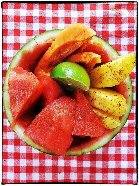 Tropical fruit with chilli and lime in a watermelon bowl
