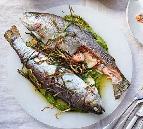 Trout with lovage, pea purée & crisp spring onions